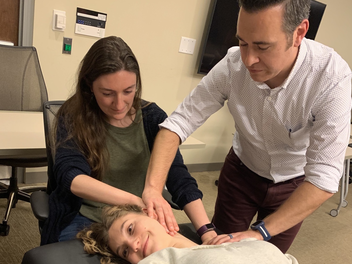 Jef Groesbeck, right, and School of Medicine student Maggie Rossano perform osteopathic manipulation treatment on medical student Caitlin Womack at a workshop Groesbeck hosted this fall for the VCU Student Family Medicine Association. (Courtesy photo)